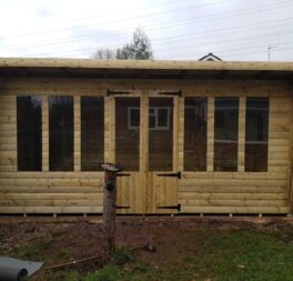 16x8 SUMMERHOUSE PENT +2FT CANOPY 19MM TAN LOGLAP 3X2 FRAME 13MM T/G ROOF
